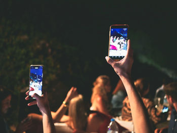 Reflection of person photographing in mobile phone