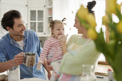Rear view of father with daughter against people
