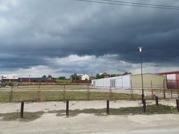 View of houses against cloudy sky