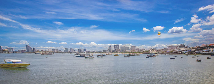 Boats in sea against buildings in city