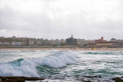 Ocean wave with bondi beach on the background. popular tourist destination background