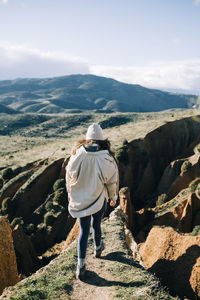 Rear view of man walking on mountain