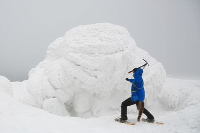 Person hiking on ice mountain