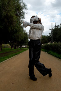 Rear view of man standing on road