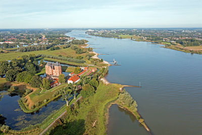 High angle view of townscape by sea against sky