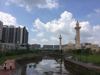 Reflection of city in water against sky