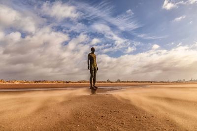 Full length of man standing on desert