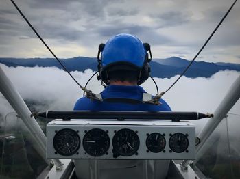 Rear view of pilot sitting in cockpit