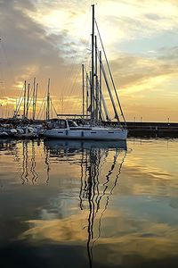 Sailboat in sea at sunset