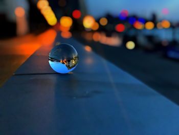 Close-up of crystal ball in city