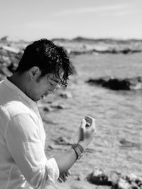 Side view of man standing on beach