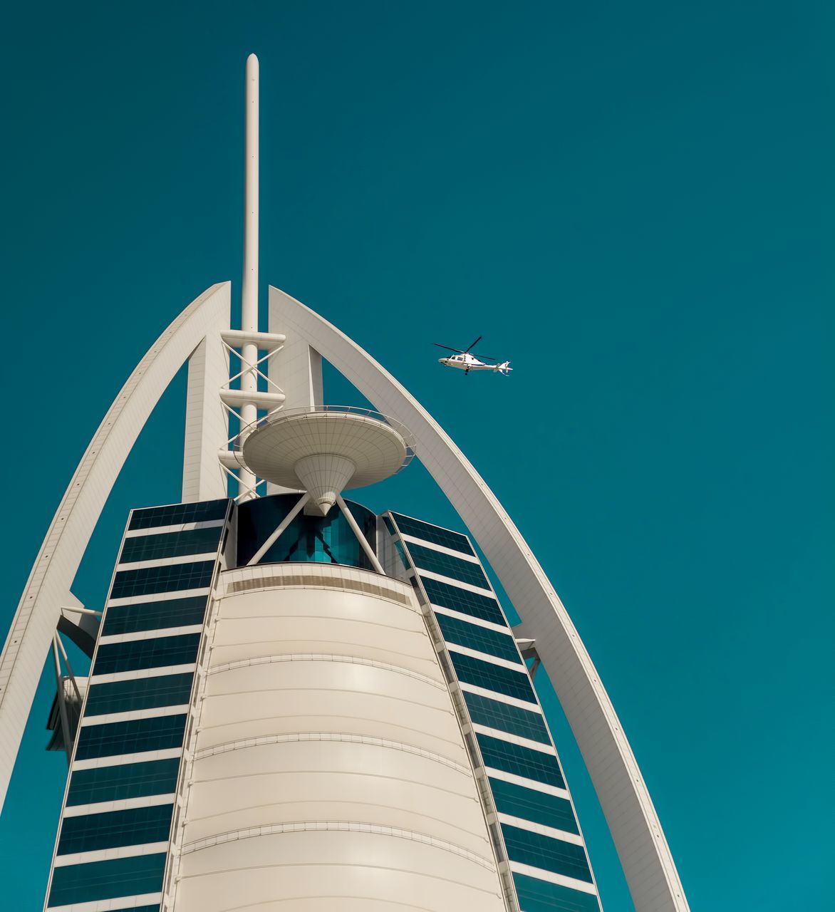 architecture, sky, built structure, building exterior, blue, nature, low angle view, air vehicle, no people, day, transportation, clear sky, travel, mode of transportation, airplane, flying, outdoors, sunlight, building, copy space, office building exterior, skyscraper