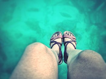 Low section of woman above swimming pool