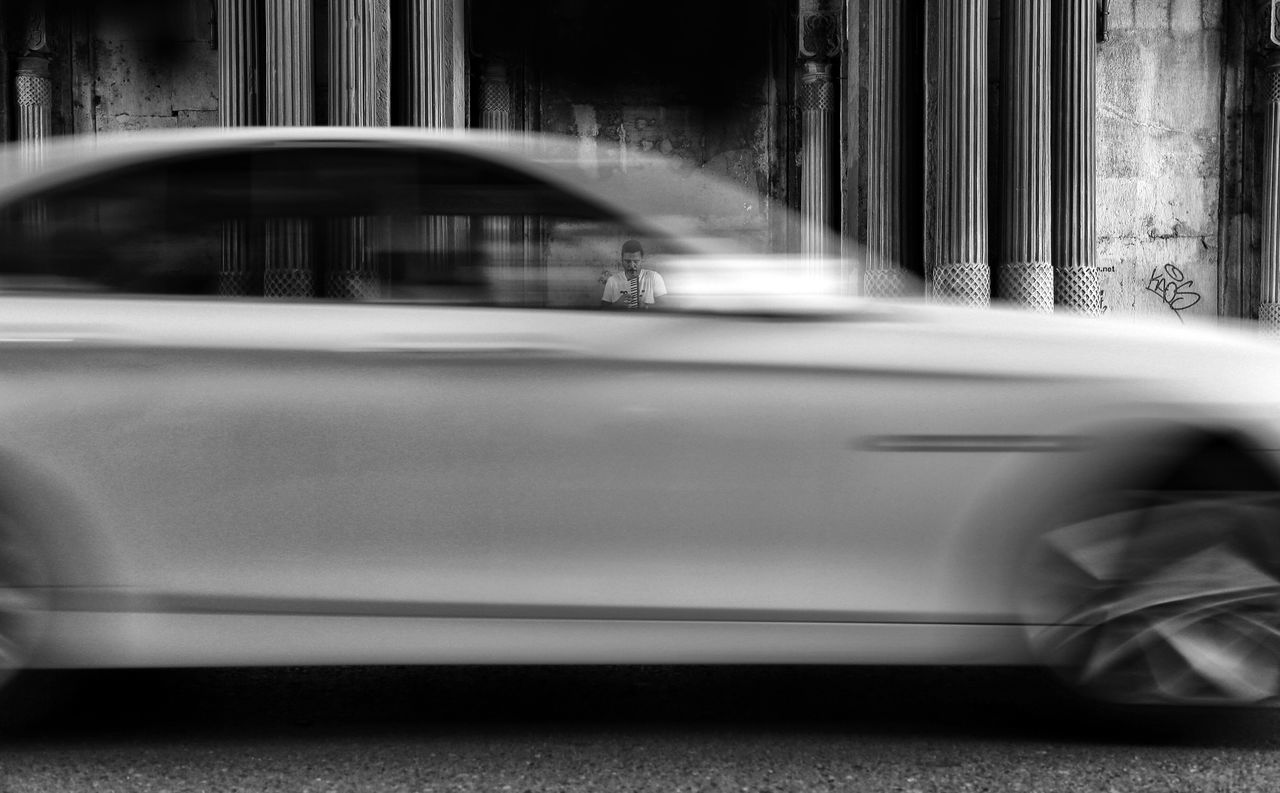 BLURRED MOTION OF CAR ON STREET