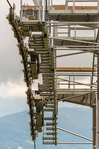 The details of a new ski lift, cableway. support pole, rope, wheels, steps, steel construction.