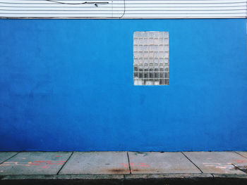 Glass window on blue wall