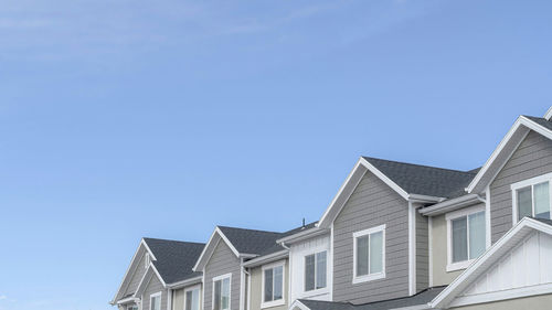 Low angle view of buildings against blue sky