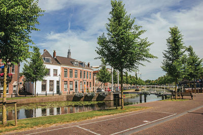 Canal with brick houses and bascule bridge in weesp. a pleasant small village in netherlands.