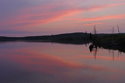 Scenic view of lake against romantic sky at sunset