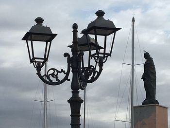 Low angle view of street light against sky