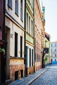 Empty alley amidst buildings in city