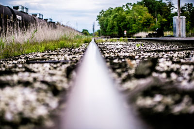 Surface level of railroad tracks against sky