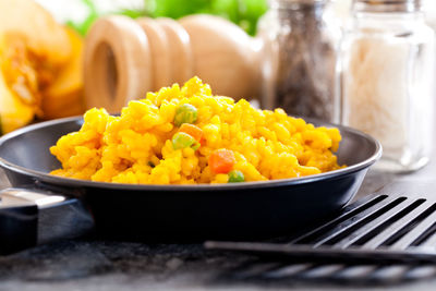 Close-up of yellow salad in bowl on table