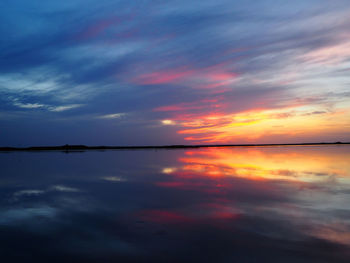 Scenic view of dramatic sky over sea during sunset