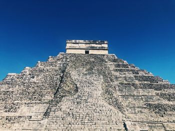 Low angle view of historical building against blue sky