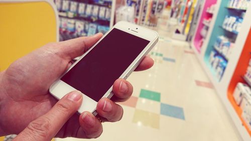 Close-up of hand holding mobile phone