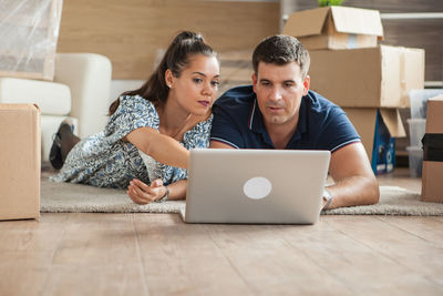 Smiling woman using laptop at home