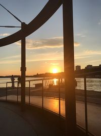 Bridge over river against sky during sunset