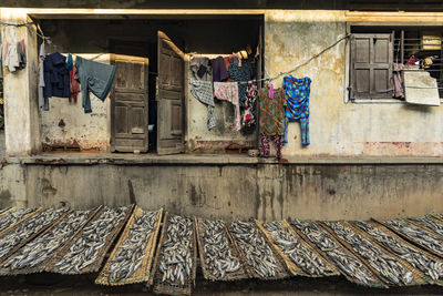 Clothes drying against wall of old building
