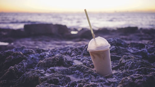 Sunset at beach in miyakojima okinawa japan and a take-out drink  banana smoothie.