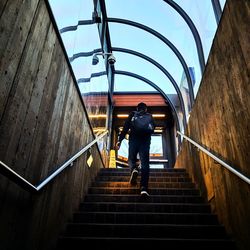 Low angle view of man on staircase of building