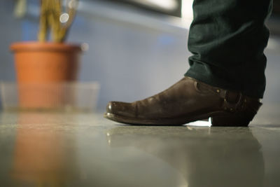 Low section of man standing on floor