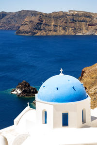 High angle view of church in oia village by sea at santorini