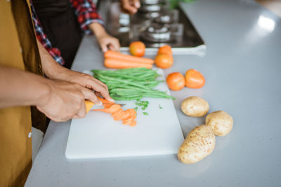 Midsection of woman preparing food on table