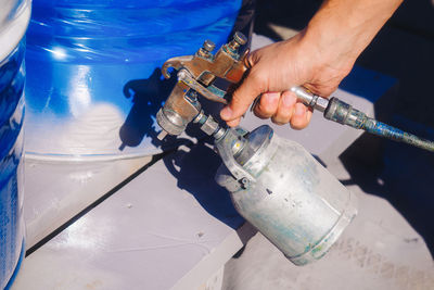 Cropped hand of man repairing pipe