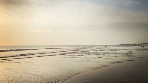 Scenic view of beach against sky during sunset