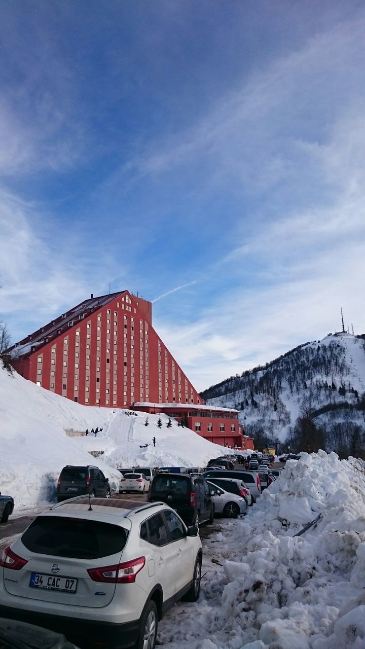 transportation, mountain, snow, winter, mode of transport, building exterior, cold temperature, sky, architecture, car, built structure, land vehicle, house, season, weather, cloud - sky, day, nature, mountain range, residential structure