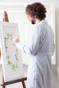 Man painting at home