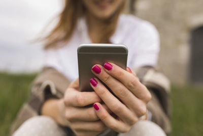 Hands of woman holding smartphone
