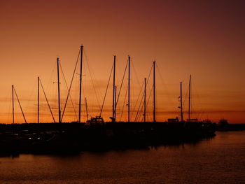 Orange sunset glow over boat silhouettes at mindarie marina.