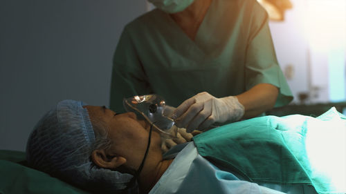 Side view of doctor examining patient at home