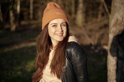 Portrait of smiling woman standing outdoors