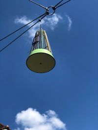 Low angle view of crane against blue sky