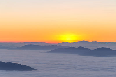 Scenic view of silhouette mountains against sky during sunset