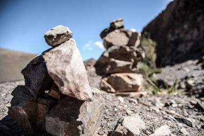 Stack of rocks against clear blue sky