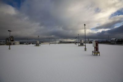 Scenic view of snow covered street against sky